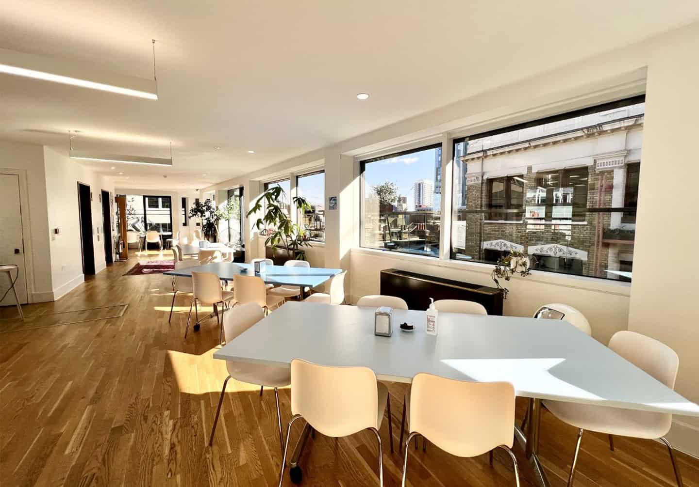Long tables and large windows in the rooftop kitchen at Spitalfields.