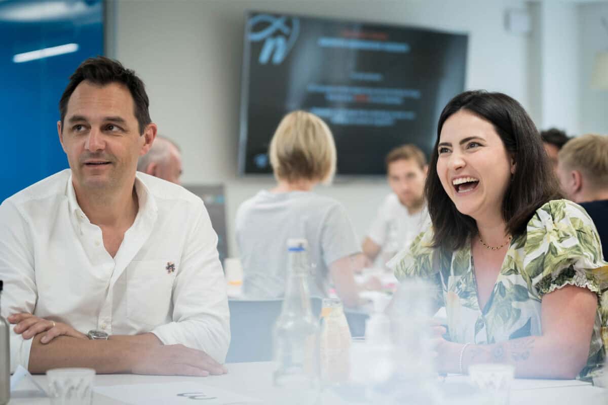 People sharing a smile during a meeting at wallacespace.